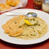 Chicken Piccata dinner  · chicken breast serve with spaghetti pasta juicy  Lemon butter sauce with capers.