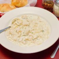 Chicken Fettuccine Alfredo with salad · Sauteed chicken breast with fettuccine in a creamy Alfredo sauce and served with a side of f...