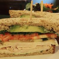 Turkey Sandwich · Oven-roasted turkey breast, avocado, tomato, cucumber, arugula and pesto aioli on toasted wh...