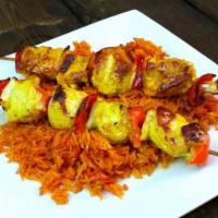 Grilled Chicken Kebobs · Two skewers of juicy marinated chicken breast topped with grilled onions and bell peppers, w...