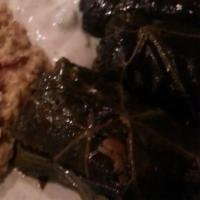 Dolmeh · Stuffed cooked grape leaves with ground beef, rice, yellow split peas and vegetables.