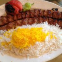 Chelo Kabob Koobideh · 2 Skewers of charbroiled juicy lean ground beef. Served with imported basmati rice topped wi...