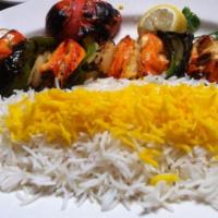 Chicken Shish Kabob · Juicy chunks of boneless breast of chicken skewered and charbroiled to perfection. Served wi...