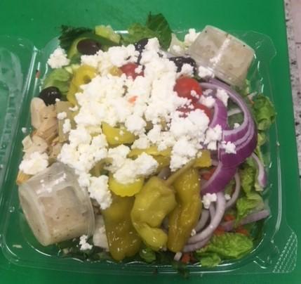 Greek Salad · Kalamata olives, pepperoncini, artichoke hearts and feta on top of a garden salad.