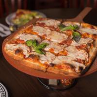 The Square Margherita Pie · Fresh mozzarella and plum tomato sauce, topped with grated Romano cheese and fresh basil.