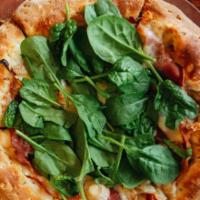 Pizza Prosciutto · Fresh mozzarella, prosciutto, baby spinach, caramelized onions and olive oil sauce.