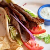Gyro Wrap · Gyro meat, lettuce, tomatoes, red onions and yogurt and garlic dressing wrapped in a warm pi...