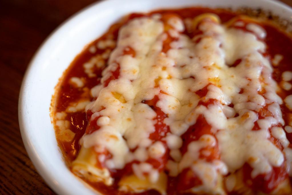 Cheese Manicotti · Pasta stuffed with ricotta and mozzarella cheese, baked in marinara sauce and topped with more mozzarella.