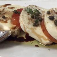 Mozzarella Caprese · Fresh mozzarella paired with vine ripened tomatoes, aged balsamic di Modena glaze and topped...