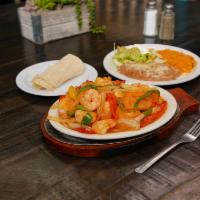 Shrimp Fajitas · Shrimp fajitas served with rice and beans. Garnished with guacamole and sour cream.