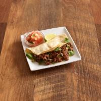Charbroiled Steak Taco · Served with onions, cilantro, and salsa ranchera.