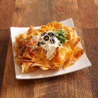 Nachos · Served with cheese, pico de gallo, guacamole, sour cream, and black olives. Add beans, chick...