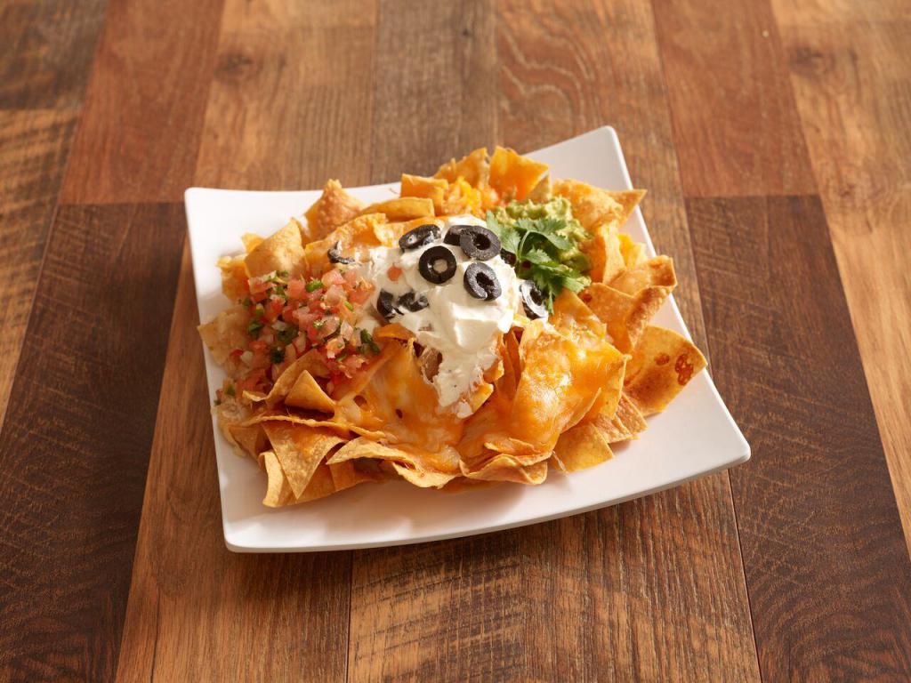 Nachos · Served with cheese, pico de gallo, guacamole, sour cream, and black olives. Add beans, chicken, steak for an additional charge.