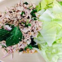 11. Larb Chicken Salad · Classic Thai chicken salad tossed with shallots, mint, toasted rice and lime dressing.