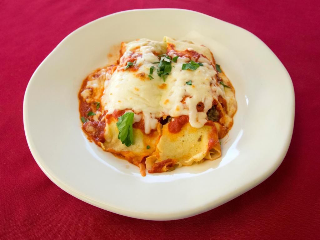 Cannelloni · Homemade cannelloni filled with ground beef, onions, mushrooms, ricotta and Parmesan cheese. Served with a side and garlic bread.