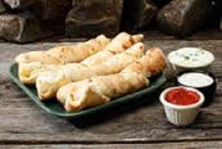 Extremely Twisted Sticks · Freshly baked dough“twisted”
with a blend of Swiss and Fontina cheeses, pureed garlic and oregano. Served with dipping sauce of your choice. 