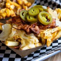 Mission Fries · Fries topped with bacon bits, cheese sauce, sauteed onions, and jalapenos.