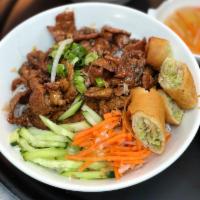 Vermicelli with Pork and Egg Roll · A bowl served with carrot strips, cucumbers, chopped peanuts, onions over shredded lettuce a...