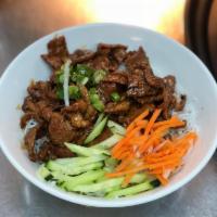 Vermicelli with Pork · A bowl served with carrot strips, cucumbers, chopped peanuts, onions over shredded lettuce a...