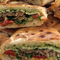 The Fritelle Panino · Two grilled meatballs, with roasted red peppers, pesto aioli, arugula and provolone cheese.