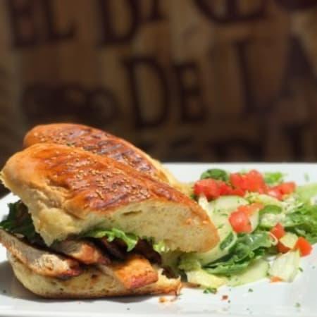 Sandwich de Pollo a la Plancha · Grilled chicken breast topped with caramelized onions, tomatoes, and Swiss cheese, pressed on fresh bread. Served with fries, salad or small soup.