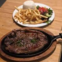 Churrasco Colombiano · A butterfly 16 oz. grilled NY strip steak center cut served with white rice, french fries, s...