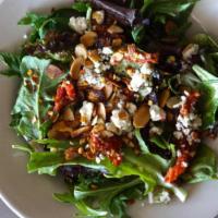 Navona Salad · Organic field greens infused with sun-dried tomatoes, Gorgonzola cheese and roasted almonds ...