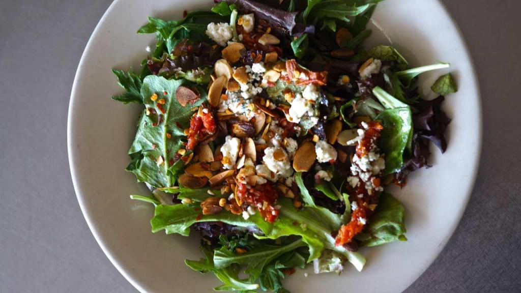 Navona Salad · Organic field greens infused with sun-dried tomatoes, Gorgonzola cheese and roasted almonds crowned with your choice of our herbal vinaigrette or homemade balsamic vinaigrette. Add grilled chicken strips for an additional charge.