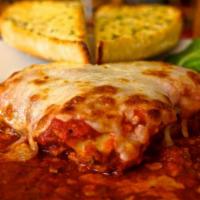 Homemade Beef Lasagna · Layers of meat stuffed pasta with mozzarella, served with with taosted garlic bread.