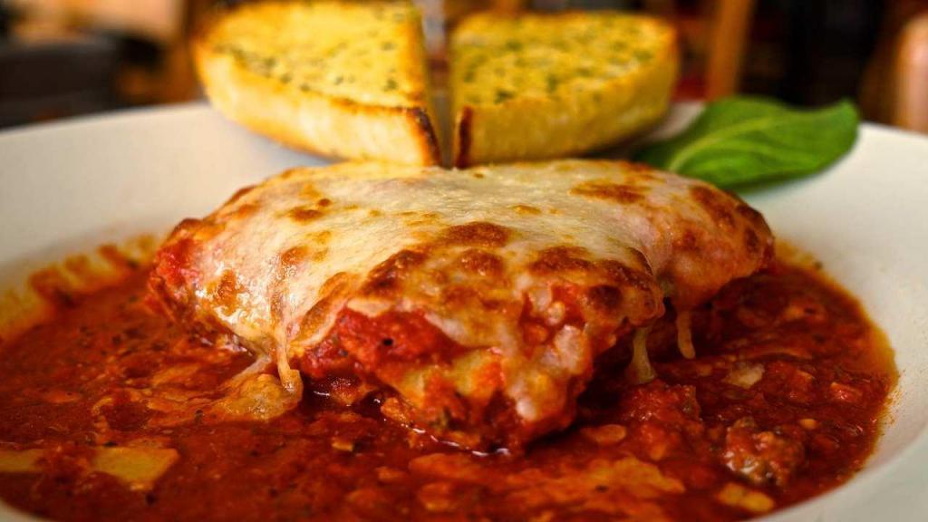 Homemade Beef Lasagna · Layered dish with wide flat pasta. Layers of meat stuffed pasta with mozzarella, served with with taosted garlic bread.