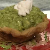Guacamole Dip · Made fresh daily! Topped with sour cream and served in a flour tortilla basket.