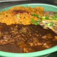 Chile Colorado · Chunks of beef simmered in our mild red chile sauce. Served with rice and beans.