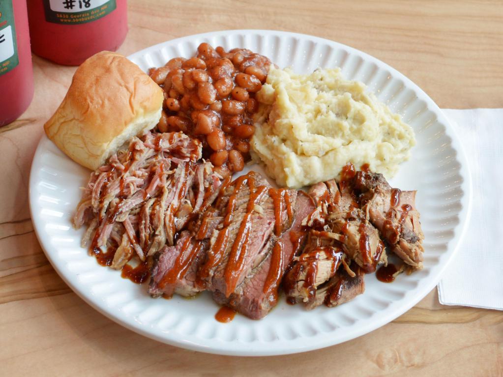 BBQ Bus Sampler · 1/4 lb. each of pulled pork, smoked chicken and Angus brisket served with bread and 2 sides. Serves 2.