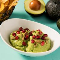 Guacamole · Pomegranate seeds, lime pepita seeds, red onion, jalapeno, and cilantro served with plantain...