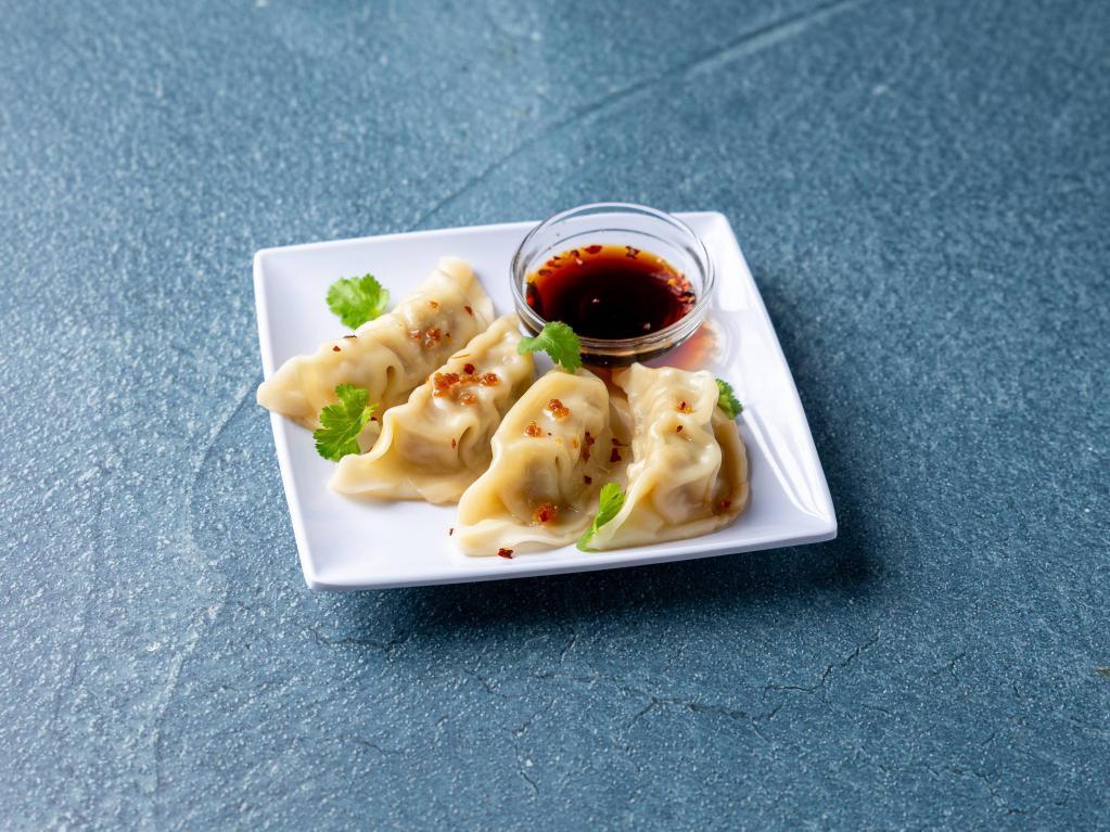 Steamed Dumpling · Chicken and vegetable dumplings steamed in the classic tradition served with vinaigrette soy sauce.