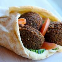 Falafel · Fried ground chickpeas with spread of hummus, parsley, onion and herbs with lettuce, tomato,...