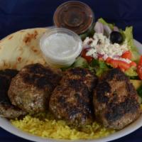 Kofta Kabob Plate · Broiled seasoned ground lamb over rice with a side Greek salad and homemade tzatziki sauce a...
