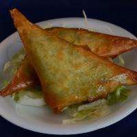 Spanakopita (2 Pieces) · Filo pastry triangle filled with spinach and feta cheese.