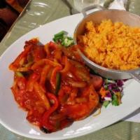 Pechuga a la Criolla · Chicken breast in criolla sauce. Includes white rice or yellow rice and beans.
