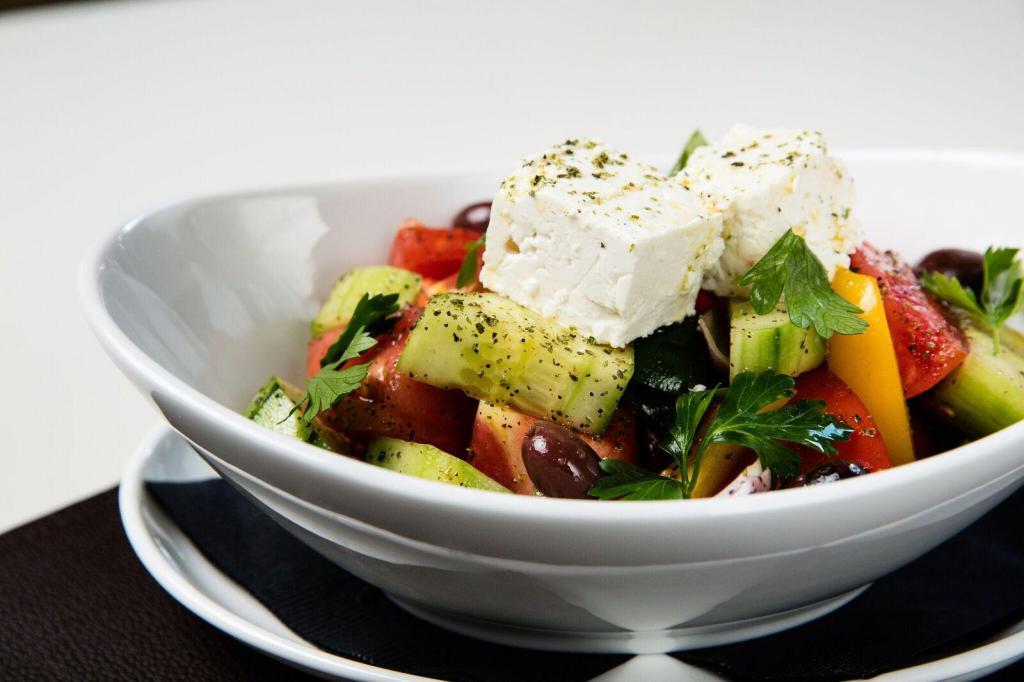 Greek Salad · Vine ripened tomatoes, cucumbers, green peppers, onions, olives, feta and extra virgin olive oil.