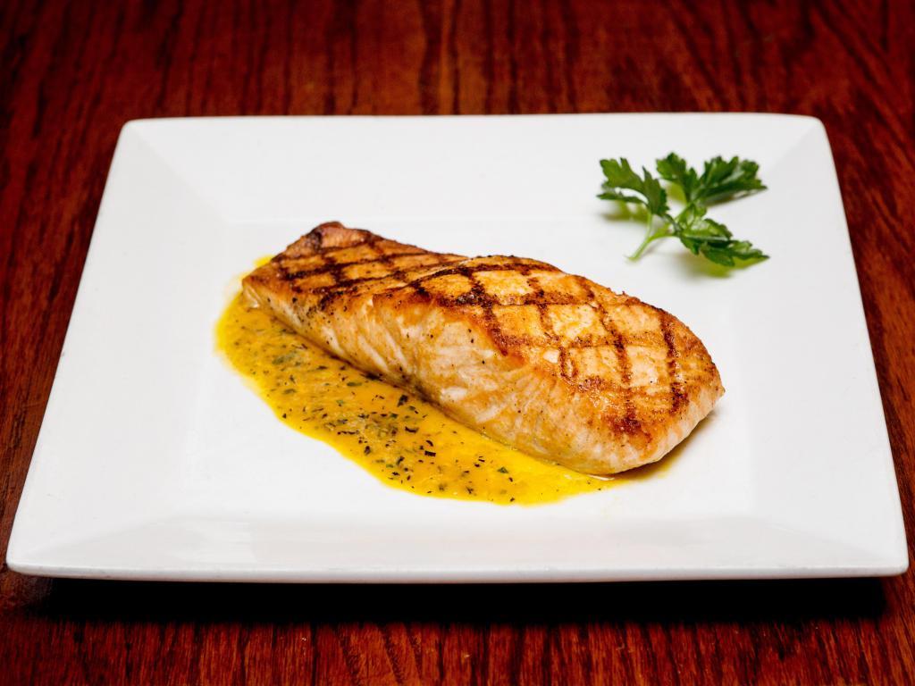 Salmon Asado · Fresh fillet of Atlantic salmon broiled, served in a bed of fresh aromatic herb sauce.