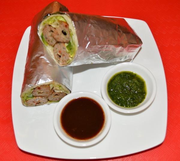 Spicy Seekh Kabab Kaati Roll · Fresh flour  with ground lamb seasoned with ginger, green chilies and spices. Served with mint and tamarind chutney.