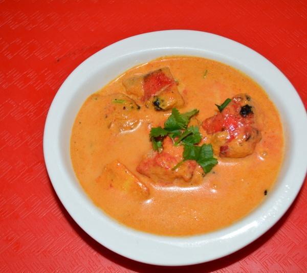 Butter Chicken Curry · Boneless tandoori chicken simmered in a mild tomato creamy sauce with cinnamon, cloves and spices.