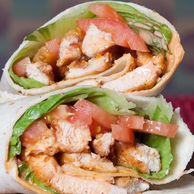 Buffalo Wrap · Golden crispy chicken tossed in our special Buffalo sauce, lettuce, tomatoes and topped with bleau cheese dressing