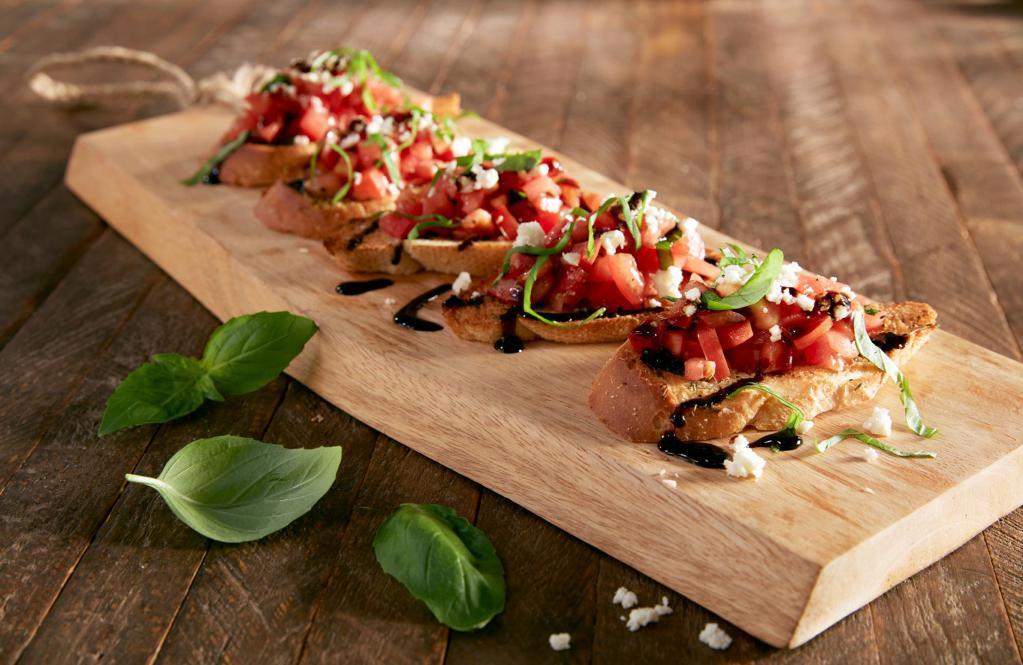 Bruschetta · Diced tomatoes, basil and seasonings tossed in balsamic vinegar and olive oil. Topped with feta and fresh basil, served on garlic toast points and drizzled with a balsamic glaze.