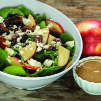 Enlightened Spinach Salad · Fresh spinach topped with dried cherries, apples, house made candied pecans and feta. Add ap...
