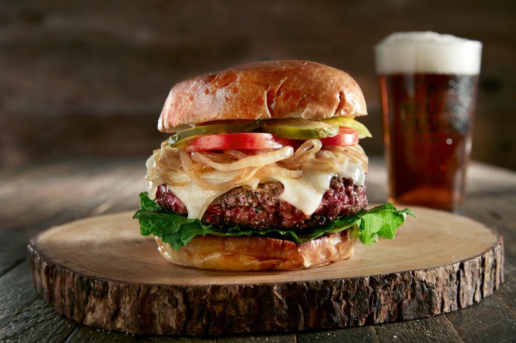 Ritz Burger · 8 oz. of 100% USDA-certified choice, all-natural black Angus beef, from family-owned and operated harris ranch. Finished with Swiss, caramelized onions, garlic aioli, romaine lettuce, sliced tomato and pickle slices. Served on a grilled brioche bun.