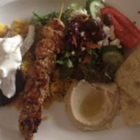 The Greek Feast · Combination of gyros meat, chicken kabob, dolmas, hummus, rice and Greek salad and pita.