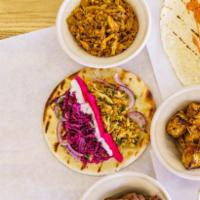 Middle Eastern Style Wrap · Pickle turnip, onion&sumac, garlic sauce, babaghanoush, red cabbage slaw, served in a warm 7...