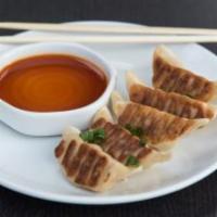Pan Fried Beef Gyoza · Spicy sesame soy dipping sauce.